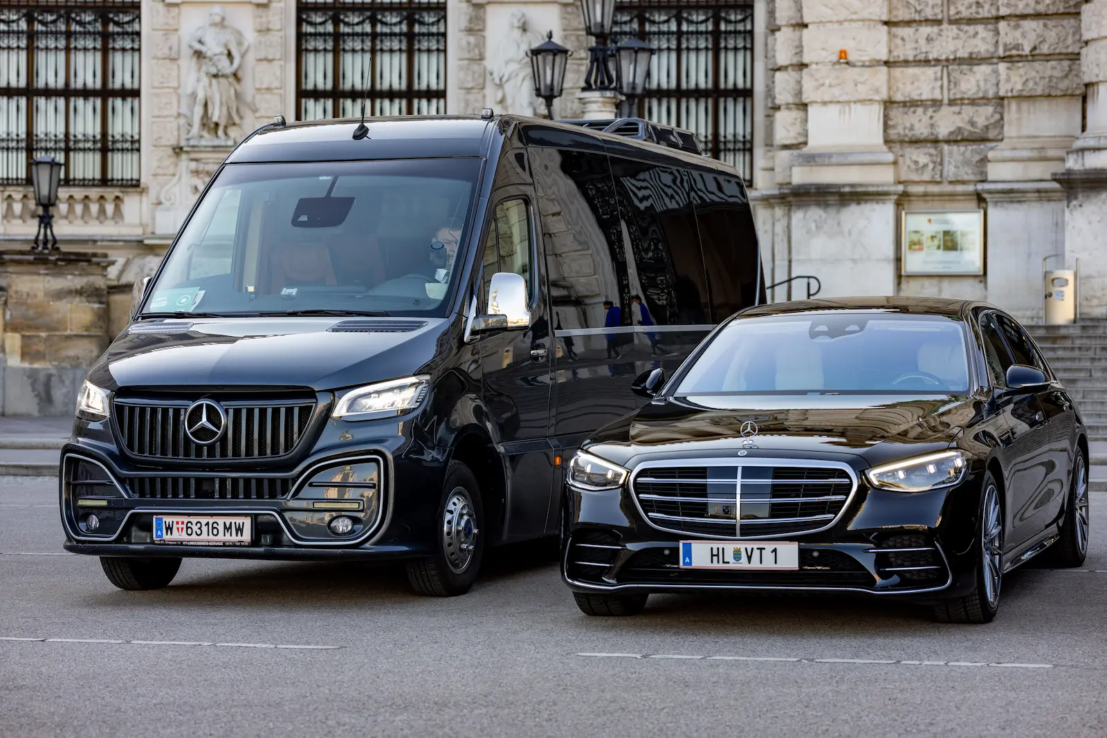 Der Limousinen Service Wien präsentiert einen schwarzen Mercedes-Van und eine Limousine vor einem historischen Gebäude in Wien.
